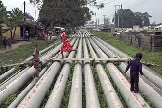 kids playing on a rack of pipelines in a residential neighborhood photo