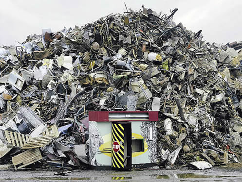 photo of a giant pile of durable garbage, with a junked autmated teller machine in the foreground