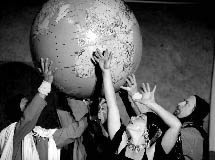 photo of people in various costumes holding a large globe