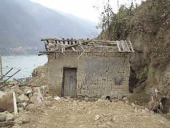 photo of a ruinous building, with a misty body of water behind